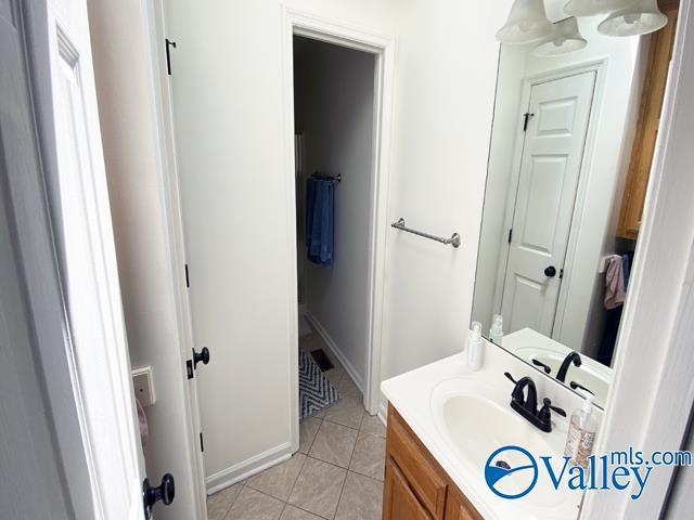 bathroom with tile patterned floors and vanity