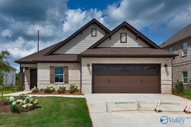 view of front of home with a garage and a front yard