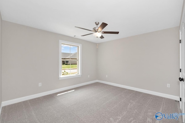 carpeted spare room featuring ceiling fan