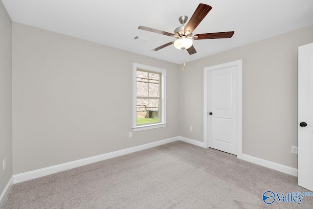 carpeted empty room featuring ceiling fan