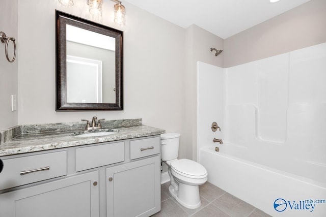 full bathroom featuring vanity, tile patterned floors, bathing tub / shower combination, and toilet