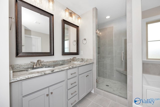 bathroom featuring tile patterned flooring, vanity, and walk in shower