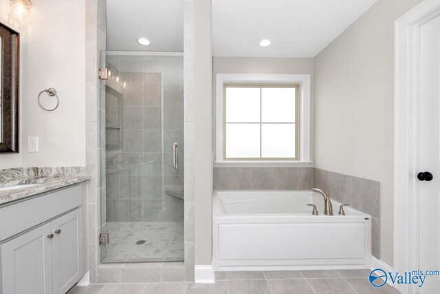 bathroom featuring tile patterned flooring, vanity, and independent shower and bath