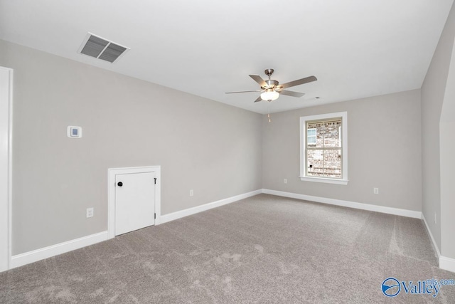 spare room with ceiling fan and carpet