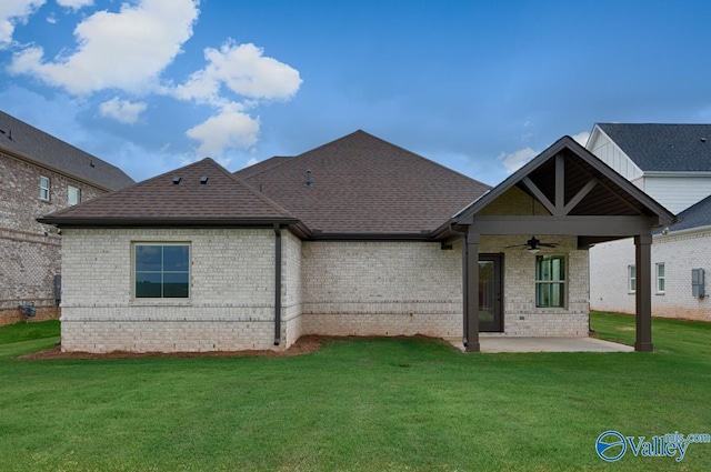 back of property featuring ceiling fan, a yard, and a patio area