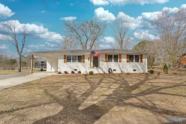 single story home with driveway, a carport, and crawl space