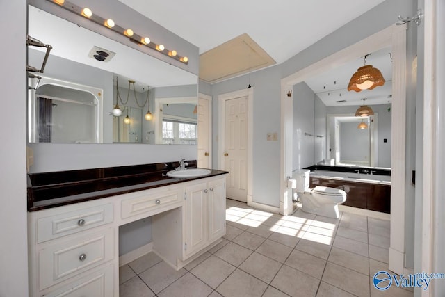 bathroom with tile patterned flooring, vanity, and toilet