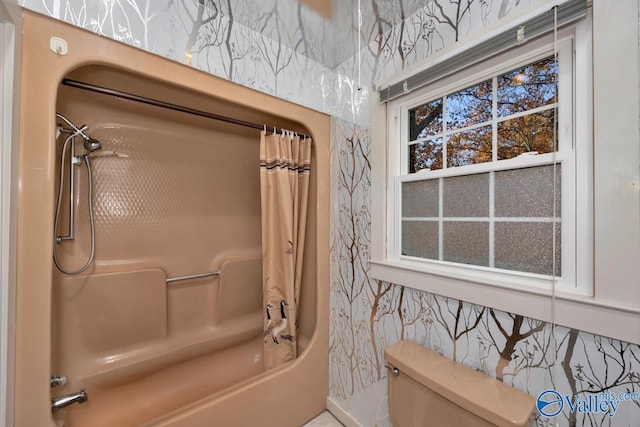 bathroom with toilet and shower / tub combo with curtain