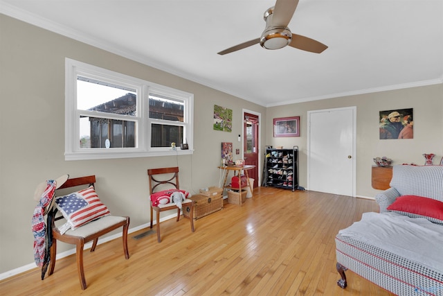 bedroom with crown molding, multiple windows, and wood-type flooring