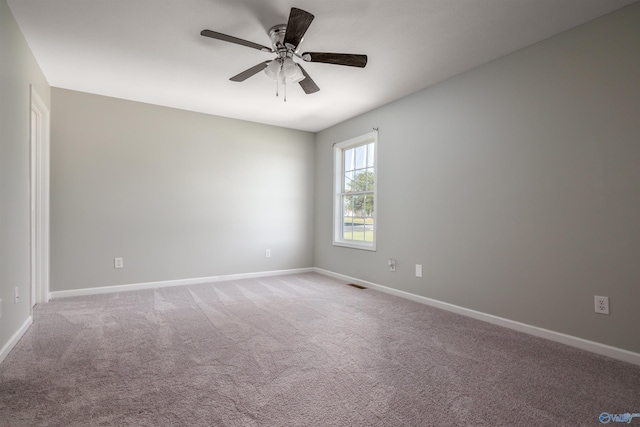 spare room with ceiling fan and carpet floors