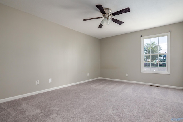 spare room with ceiling fan and carpet floors