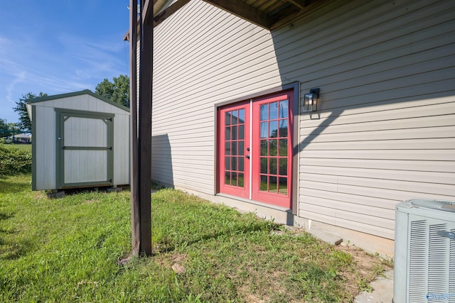 view of property exterior with central AC unit, a storage shed, and a lawn