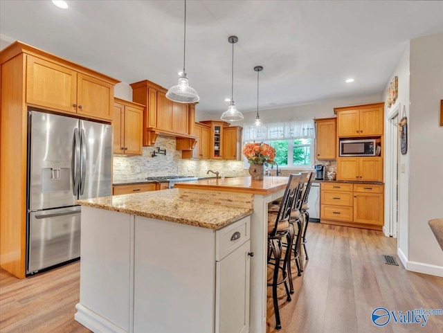 591 Nix Rd, Hazel Green, AL 35750 - kitchen with appliances with stainless steel finishes, decorative backsplash, recessed lighting, and light wood-type flooring