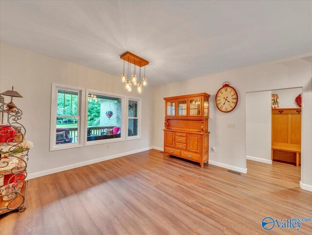 591 Nix Rd, Hazel Green, AL 35750 - dining room with light wood-style floors, a chandelier, and baseboards