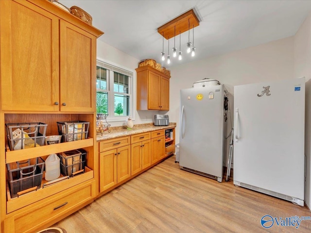 591 Nix Rd, Hazel Green, AL 35750 - kitchen with freestanding refrigerator, light wood finished floors, and hanging light fixtures