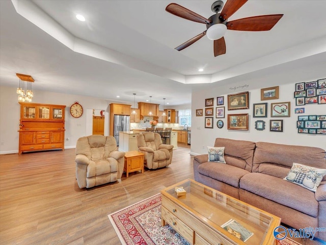 591 Nix Rd, Hazel Green, AL 35750 - living area featuring recessed lighting, ceiling fan, light wood-style floors, a raised ceiling, and baseboards
