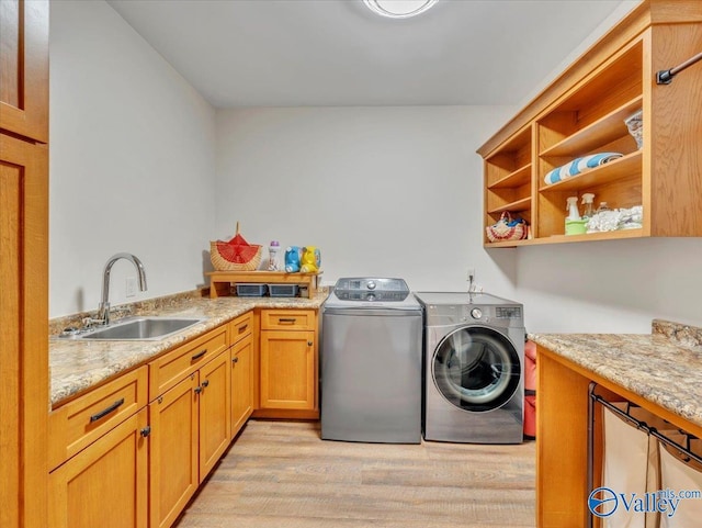 591 Nix Rd, Hazel Green, AL 35750 - clothes washing area featuring washing machine and dryer, light wood finished floors, and cabinet space