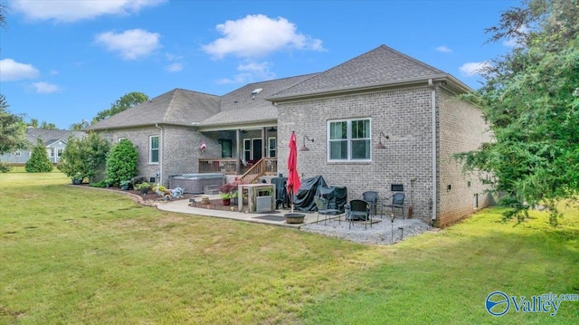 591 Nix Rd, Hazel Green, AL 35750 - rear view of property featuring a hot tub, a patio area, brick siding, and a yard