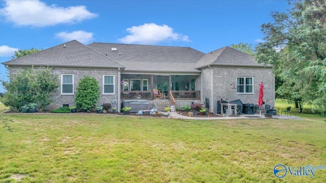 591 Nix Rd, Hazel Green, AL 35750 - back of property with brick siding, a patio area, a yard, and a shingled roof