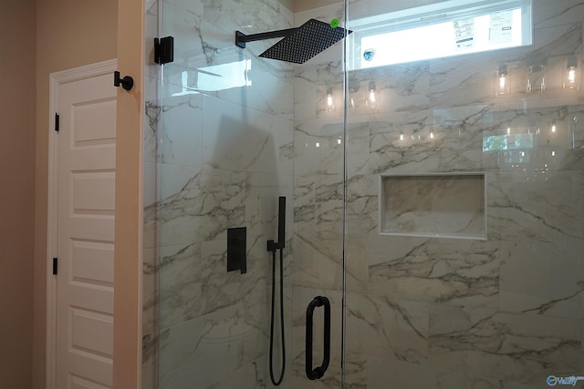 bathroom with a marble finish shower