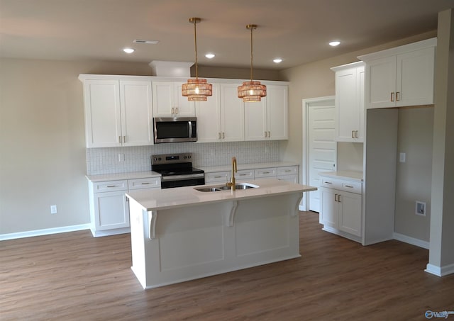 kitchen featuring a sink, white cabinets, appliances with stainless steel finishes, and tasteful backsplash