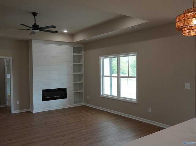 unfurnished living room featuring dark wood-style floors, baseboards, and recessed lighting