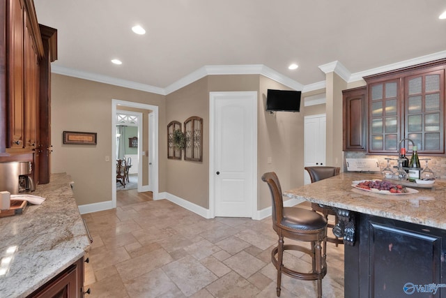 201 Atwater Dr, Madison, AL 35756 - kitchen featuring baseboards, stone tile floors, a breakfast bar area, light stone counters, and recessed lighting
