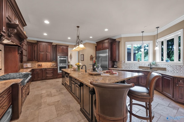 201 Atwater Dr, Madison, AL 35756 - kitchen featuring stainless steel appliances, backsplash, an island with sink, light stone counters, and recessed lighting