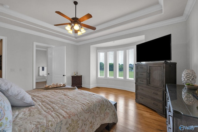 201 Atwater Dr, Madison, AL 35756 - bedroom featuring a tray ceiling, light wood-type flooring, baseboards, crown molding, and ceiling fan