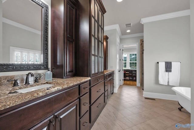 201 Atwater Dr, Madison, AL 35756 - bathroom featuring crown molding, baseboards, a soaking tub, vanity, and tile patterned floors