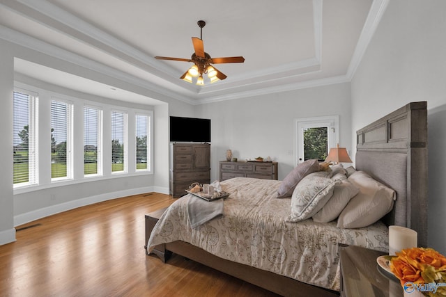 201 Atwater Dr, Madison, AL 35756 - bedroom with a tray ceiling, wood finished floors, baseboards, ornamental molding, and a ceiling fan