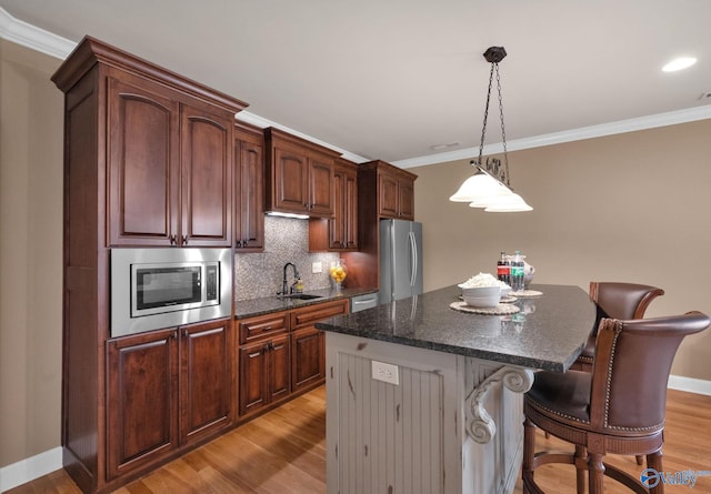 201 Atwater Dr, Madison, AL 35756 - kitchen featuring stainless steel appliances, a kitchen bar, a sink, tasteful backsplash, and a center island