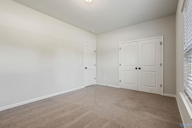 unfurnished bedroom featuring a closet and carpet