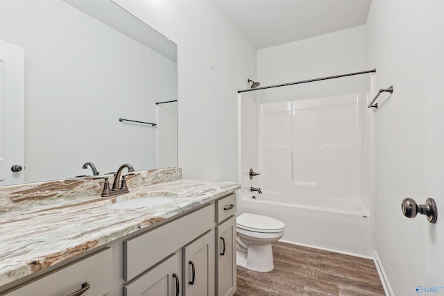 full bathroom featuring wood-type flooring, shower / bathing tub combination, vanity, and toilet