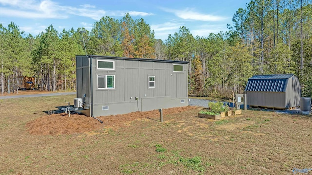 view of outbuilding featuring a yard