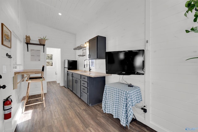 kitchen featuring gray cabinetry, stainless steel fridge, dark hardwood / wood-style flooring, and sink