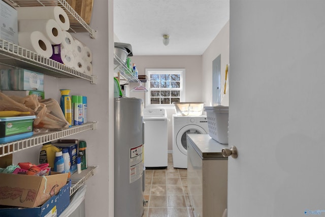 laundry area with washing machine and clothes dryer, light tile patterned flooring, laundry area, and water heater