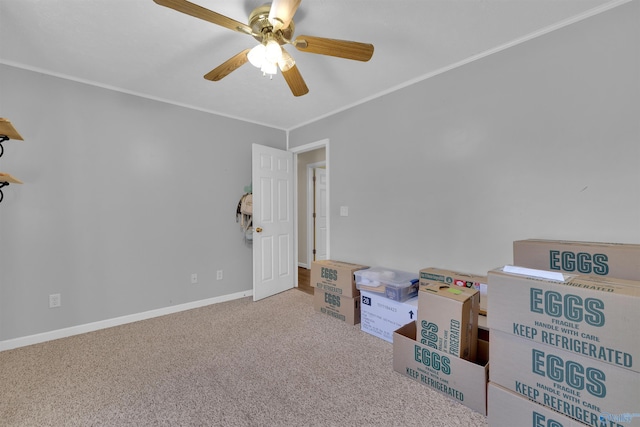 recreation room with carpet flooring, ceiling fan, crown molding, and baseboards