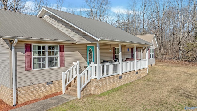 view of front of house with crawl space, a front lawn, a porch, and metal roof