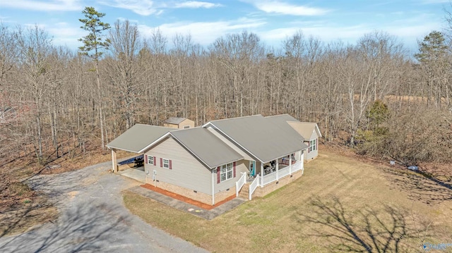 birds eye view of property featuring a wooded view