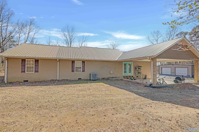 exterior space with an outbuilding, cooling unit, french doors, metal roof, and crawl space