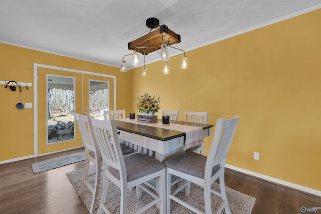 dining space featuring baseboards, french doors, dark wood-style flooring, and ornamental molding