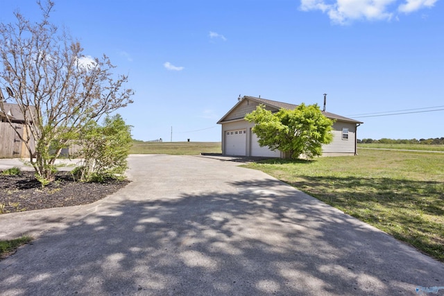 exterior space with a lawn, driveway, and a garage