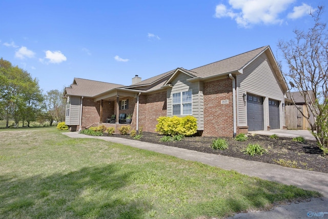 view of front of home with brick siding, an attached garage, a chimney, and a front lawn