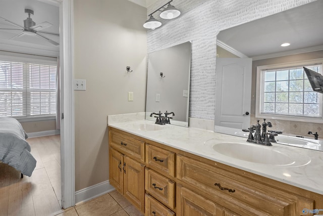 full bathroom with a ceiling fan, baseboards, a sink, and ornamental molding