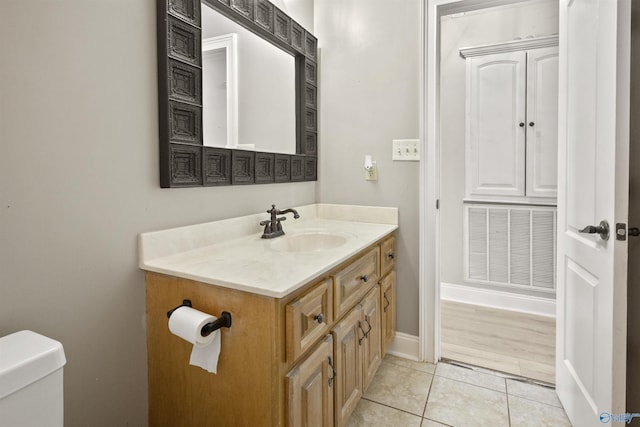 bathroom with vanity, baseboards, toilet, tile patterned flooring, and visible vents