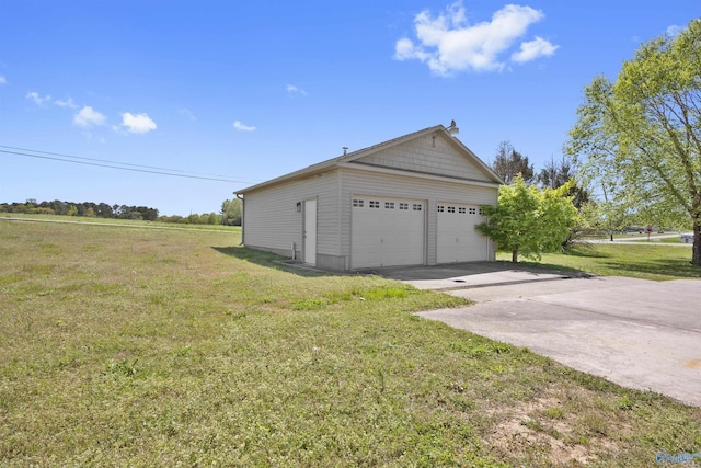 view of side of home featuring a garage and a lawn
