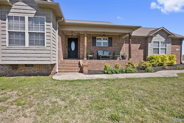 view of front of property with crawl space, a front lawn, and brick siding