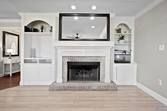 unfurnished living room featuring baseboards, wood finished floors, ceiling fan, crown molding, and a fireplace