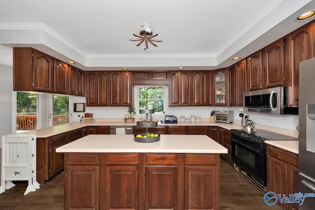 9046 Sugar Tree Trl, Huntsville, AL 35802 - kitchen featuring appliances with stainless steel finishes, light countertops, dark wood-style floors, a kitchen island, and recessed lighting
